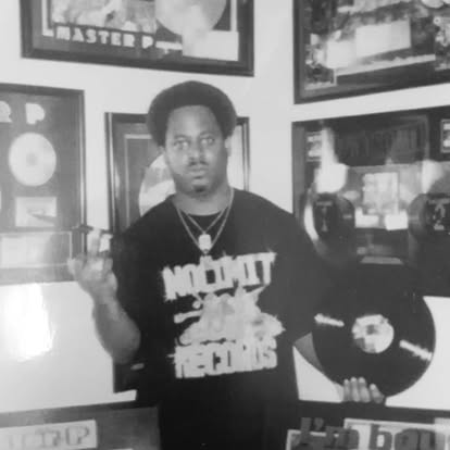 DJ Cat-X with platinum and gold record plaques